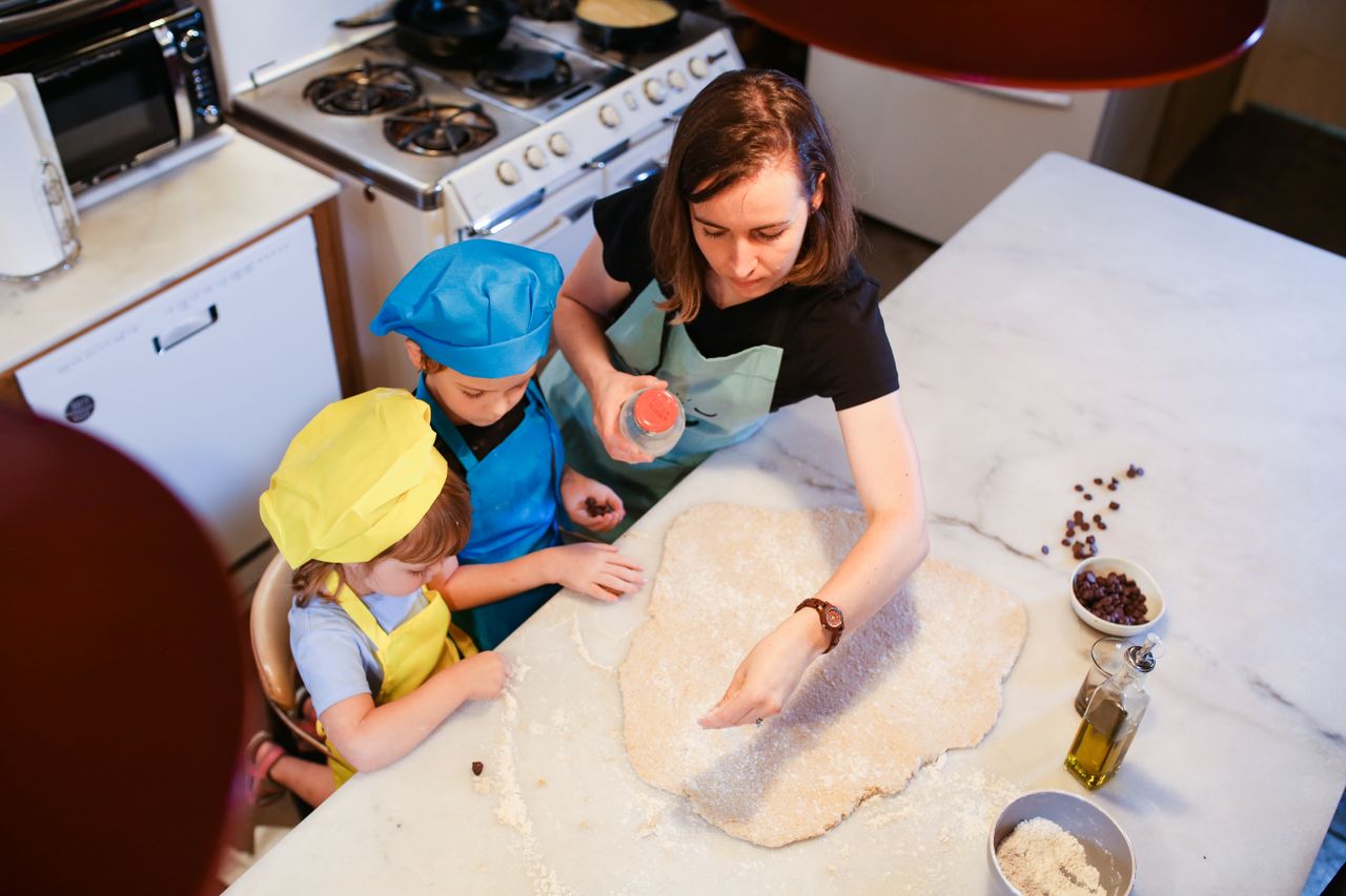 Mastering the First Impression: Your intriguing post title goes here Mother and children baking homemade cookies in the kitchen for quality family time.